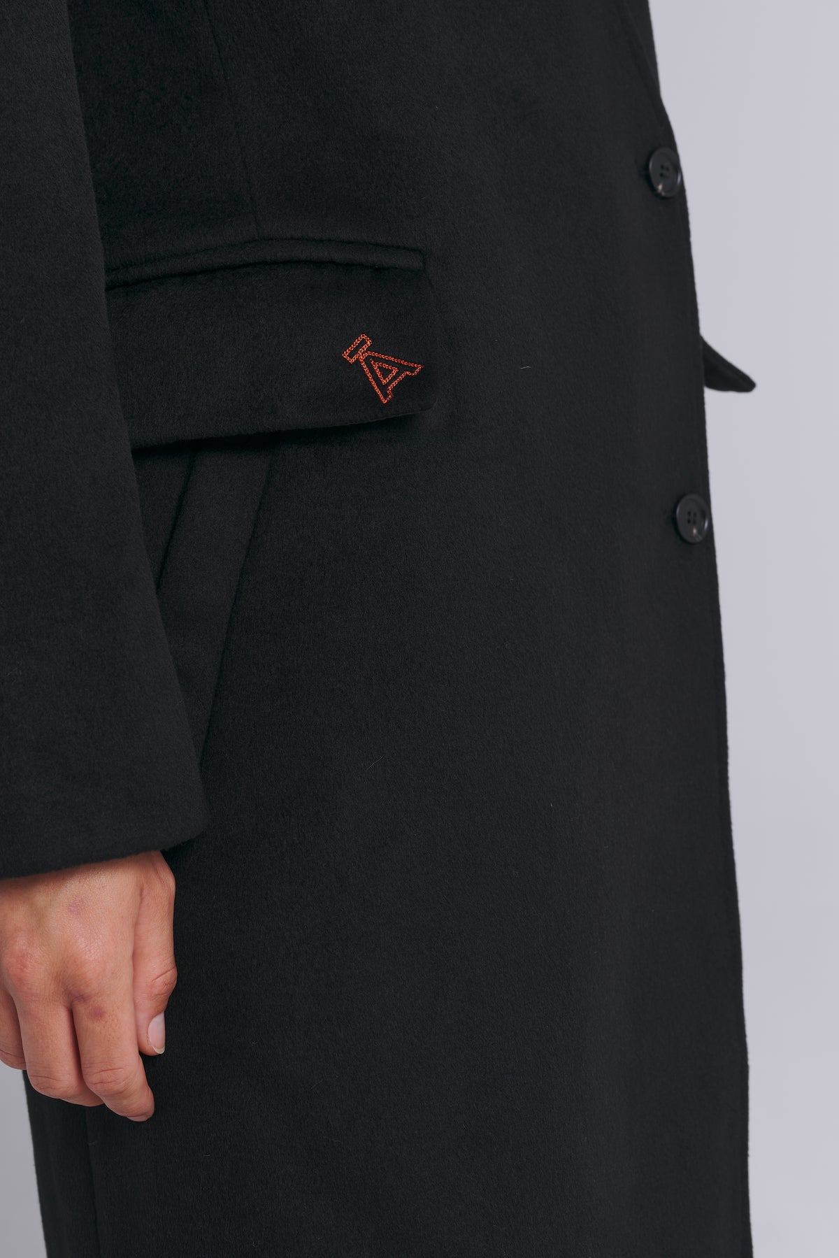 Black wool coat with detachable collar and shoulder pads by AEMMI
