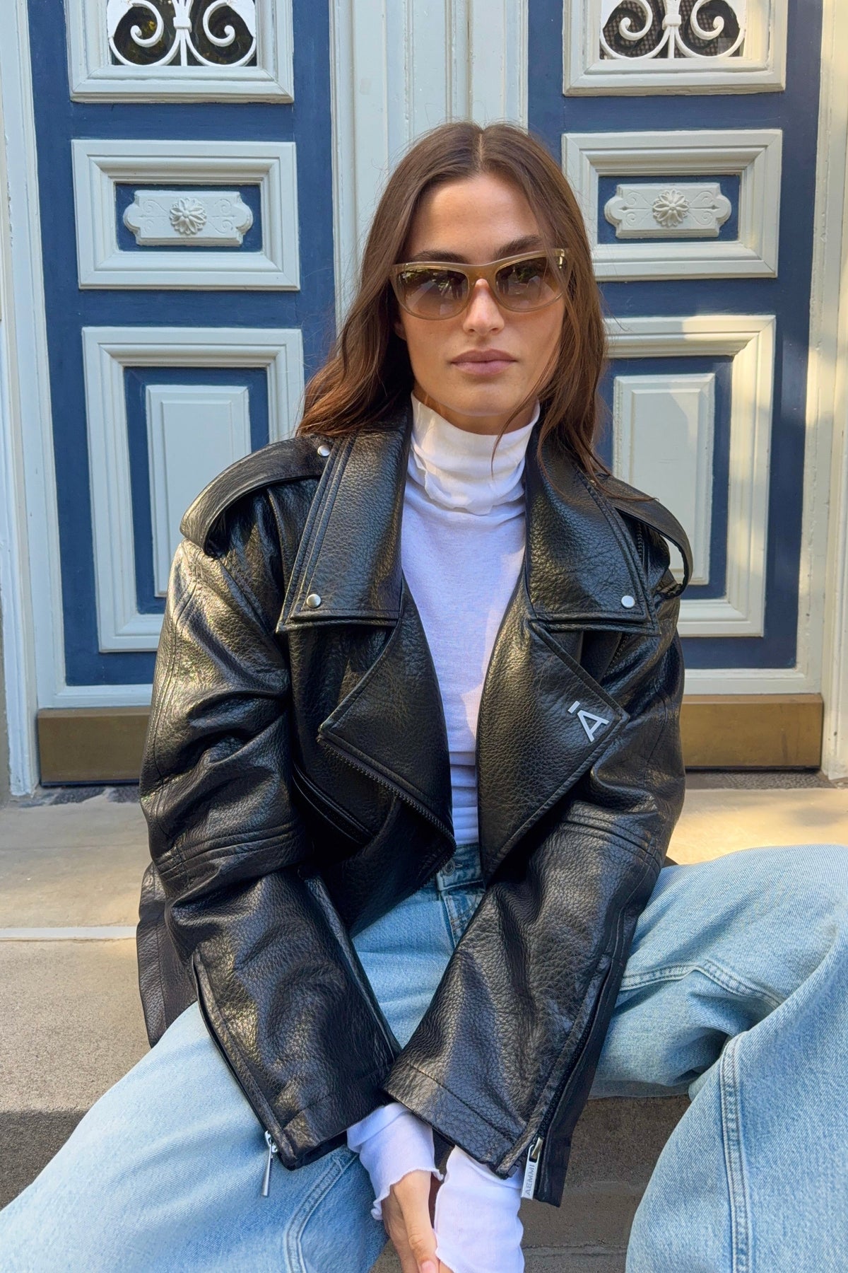 Black faux leather oversized biker jacket by AEMMI